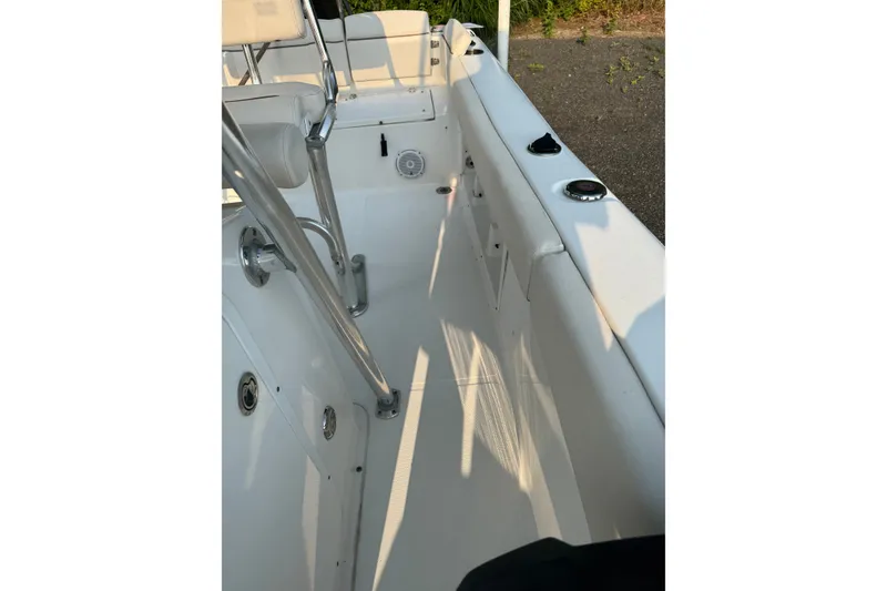 Slide: The Image of 2020 Sea Hunt Ultra 211 boat interior with seating and stainless steel fixtures. - 13