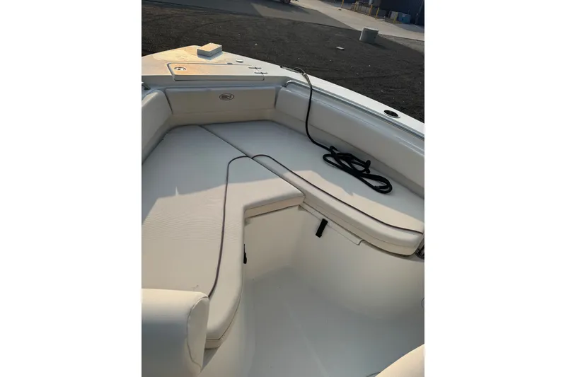 Slide: The Image of 2020 Sea Hunt Ultra 211 boat interior with cushioned seating and coiled rope. - 10