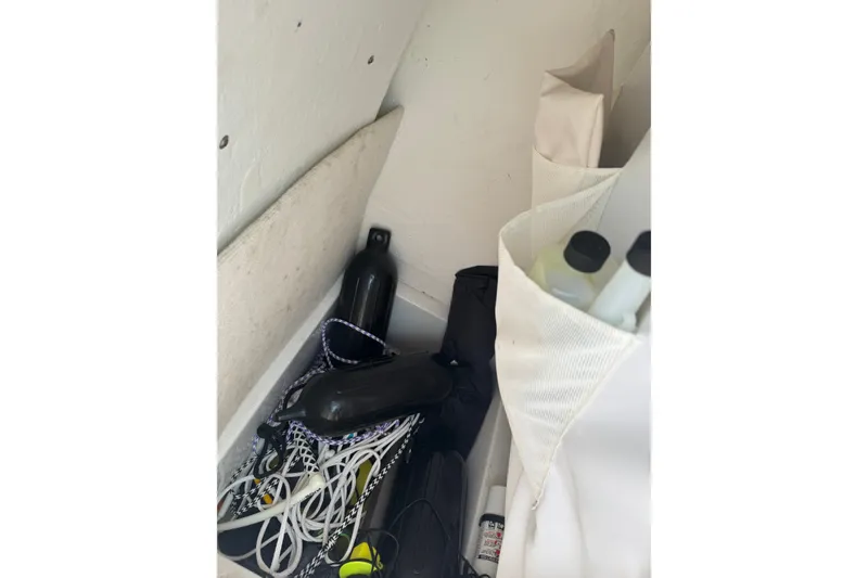 Slide: The Image of Storage compartment in a 2020 Sea Hunt Ultra 211 boat with ropes and bottles. - 9