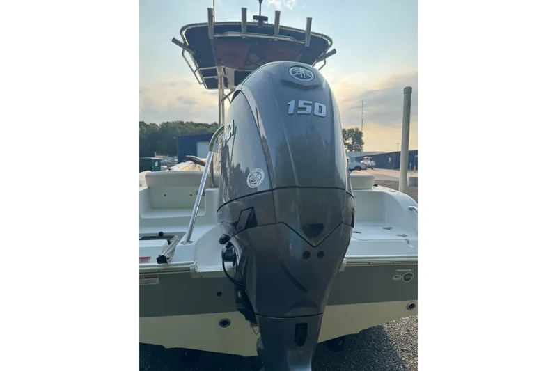 Slide: The Image of 2020 Sea Hunt Ultra 211 boat with Yamaha 150 outboard motor, docked outdoors. - 3