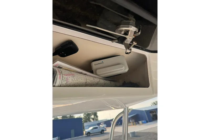 Slide: The Image of Storage compartment in a 2020 Sea Hunt Ultra 211 boat with Garmin device and nautical chart. - 8
