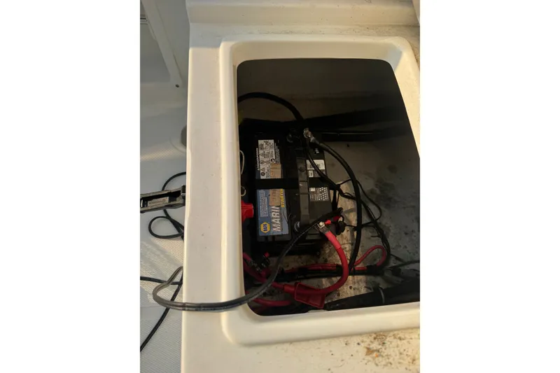 Slide: The Image of Battery compartment of a 2020 Sea Hunt Ultra 211 boat with visible wiring. - 15