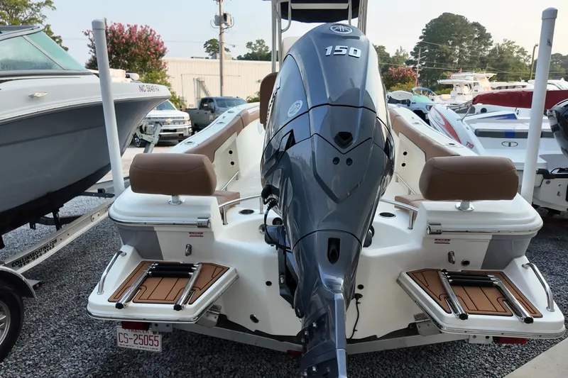 Slide: The Image of 2025 Pioneer 202 Sportfish boat with powerful 150 HP engine, displayed in a marina. - 14