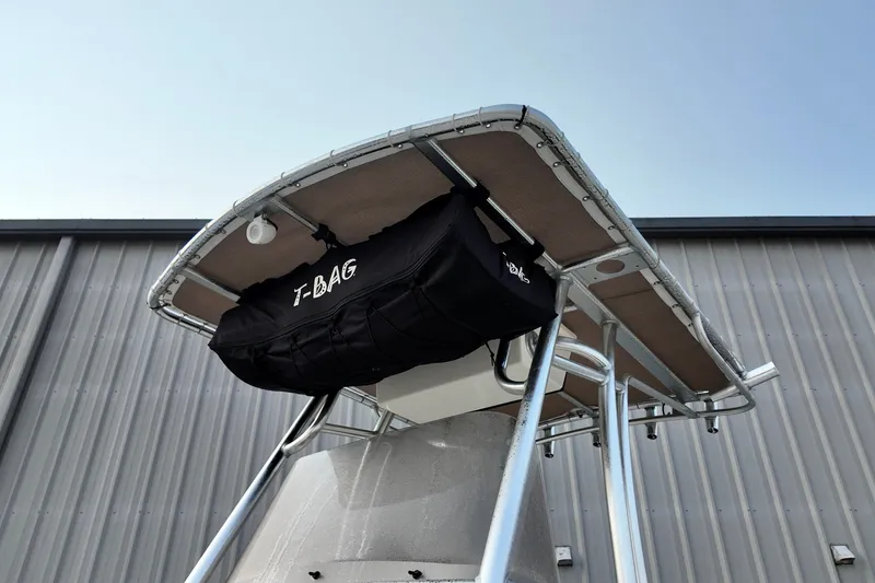 Slide: The Image of T-top of 2025 Pioneer 202 Sportfish boat with T-BAG storage against blue sky. - 7