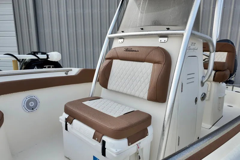 Slide: The Image of 2025 Pioneer 202 Sportfish boat interior with cushioned seating and storage. - 8