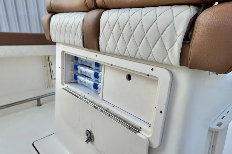 Slide: The Image of 2025 Pioneer 202 Sportfish boat seat with storage compartment and tackle boxes. - 6