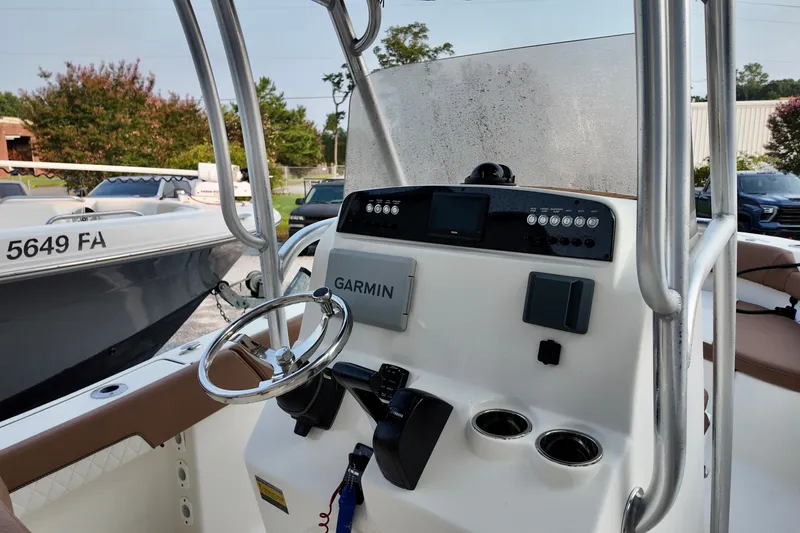 Slide: The Image of 2025 Pioneer 202 Sportfish boat dashboard with Garmin navigation system and steering wheel. - 18