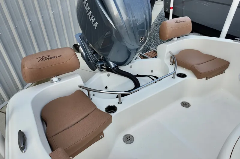Slide: The Image of 2025 Pioneer 202 Sportfish boat interior with Yamaha engine and cushioned seating. - 17