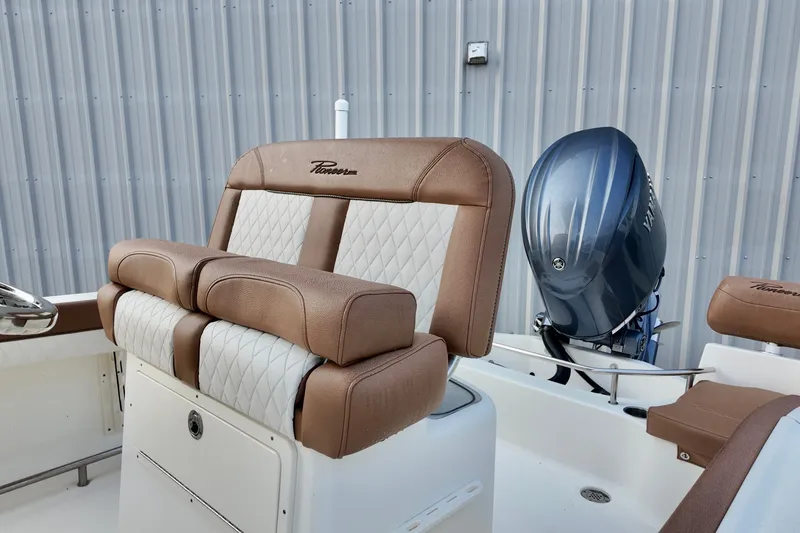 Slide: The Image of 2025 Pioneer 202 Sportfish boat interior with cushioned seating and outboard motor. - 11