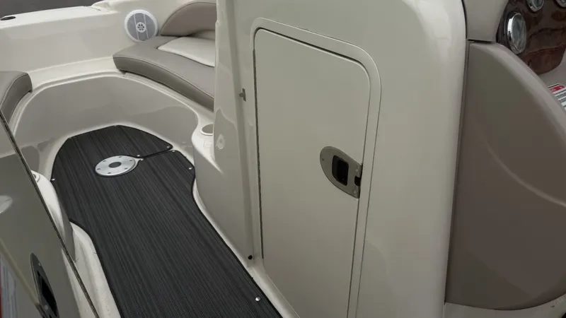 Slide: The Image of The image shows the interior of a 2004 Sea Ray 200 Sundeck boat with seating and storage. - 15