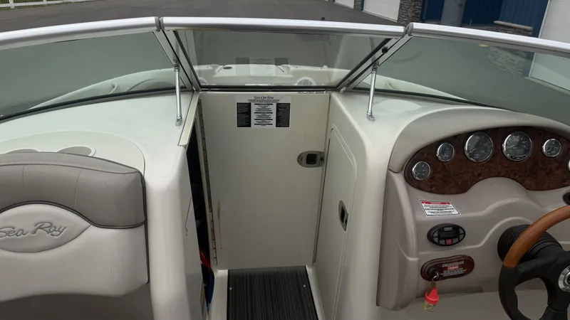 Slide: The Image of The image shows the cockpit of a 2004 Sea Ray 200 Sundeck boat with a helm and seating. - 17