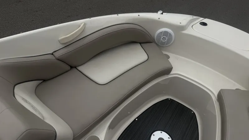 Slide: The Image of The image shows the bow seating area of a Sea Ray 200 Sundeck boat with cushioned seats. - 19