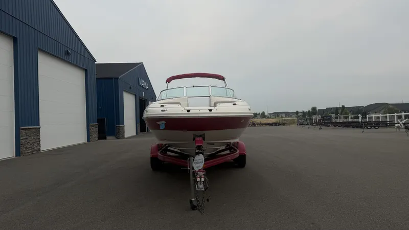 Slide: The Image of A 2004 Sea Ray 200 Sundeck on a trailer in front of a blue building. - 5