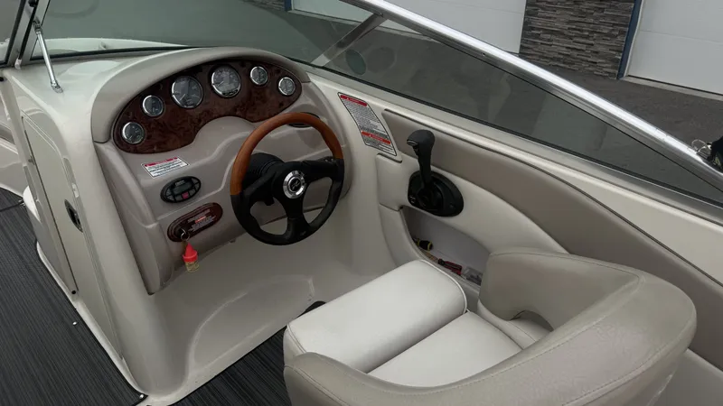 Slide: The Image of The image shows the cockpit of a 2004 Sea Ray 200 Sundeck boat with a sleek dashboard. - 27