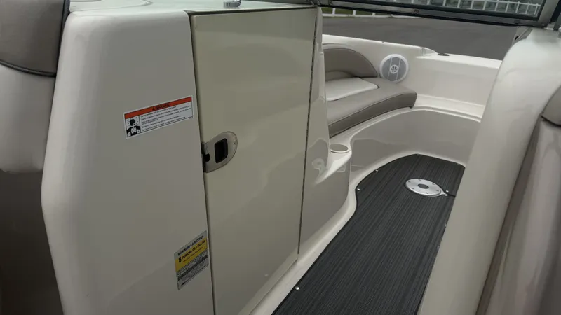 Slide: The Image of The image shows the interior of a 2004 Sea Ray 200 Sundeck boat with seating and storage. - 14