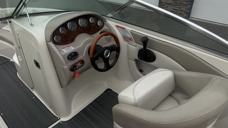 Slide: The Image of The image shows the cockpit of a 2004 Sea Ray 200 Sundeck boat with a sleek dashboard. - 13