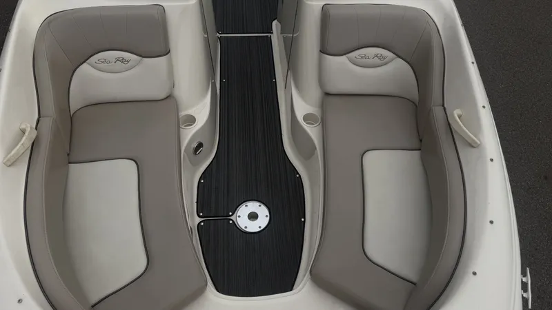 Slide: The Image of Interior view of a 2004 Sea Ray 200 Sundeck with gray and beige seating. - 22