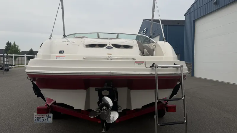Slide: The Image of A 2004 Sea Ray 200 Sundeck on a trailer. It features a swim ladder at the stern. - 8