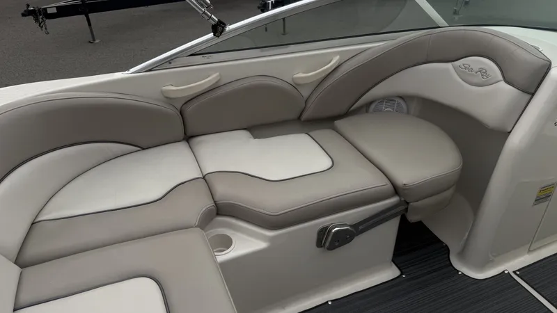 Slide: The Image of The 2004 Sea Ray 200 Sundeck features an elegant, cushioned seating area with gray and beige upholstery. - 12