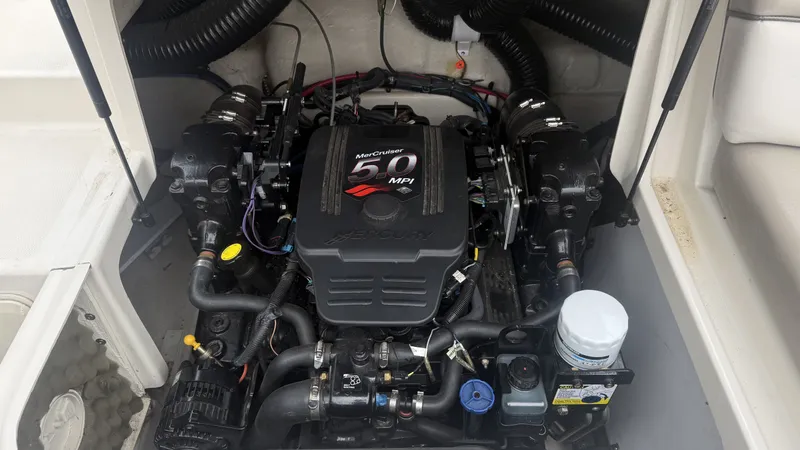 Slide: The Image of The engine compartment of a 2004 Sea Ray 200 Sundeck features a MerCruiser 5.0 MPI engine. - 23