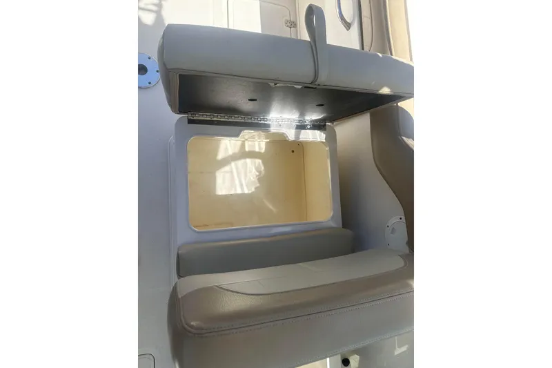 Slide: The Image of 2018 Sailfish 245 DC boat seat with open storage compartment. - 14