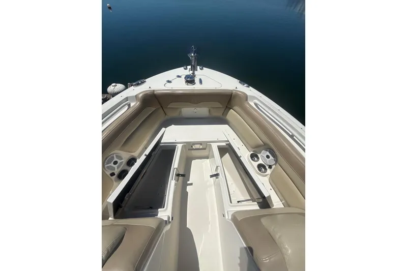 Slide: The Image of 2018 Sailfish 245 DC boat interior with seating and storage compartments. - 18