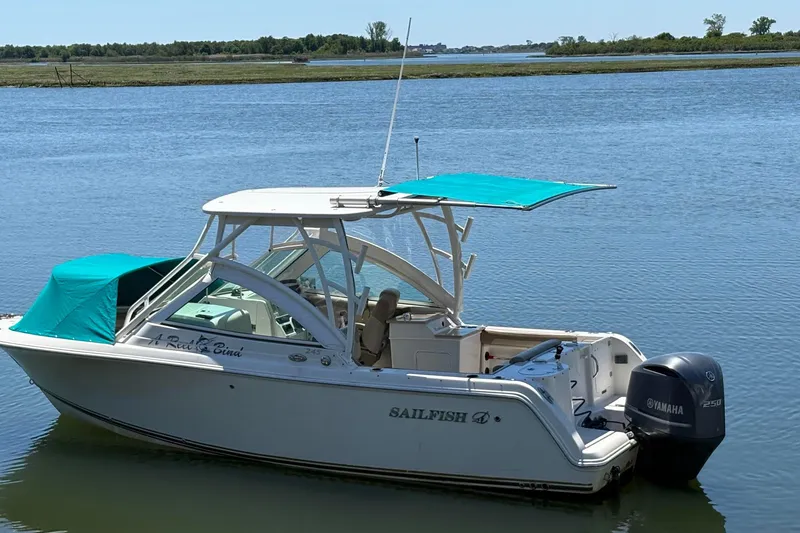 Slide: The Image of 2018 Sailfish 245 DC boat with Yamaha engine on calm water. - 6