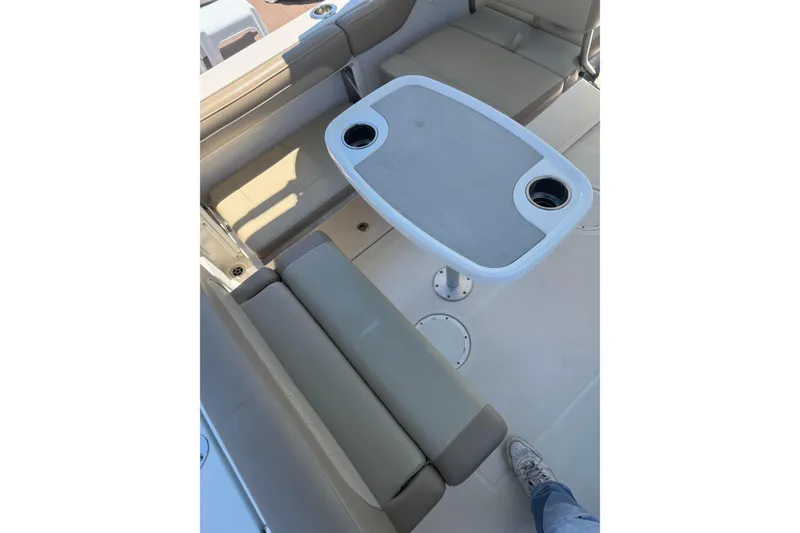 Slide: The Image of Interior of 2018 Sailfish 245 DC boat with seating and table setup. - 27