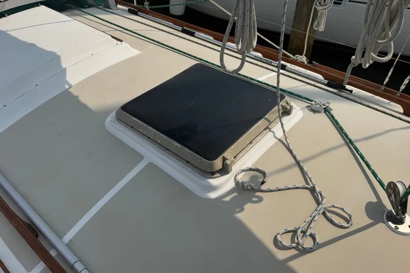 Slide: The Image of 1986 Cape Dory 36 sailboat deck with hatch and rigging ropes. - 22