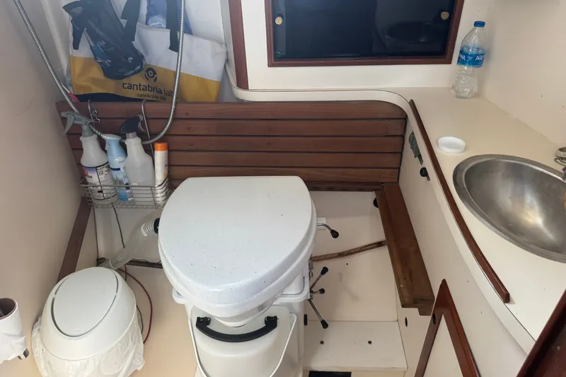 Slide: The Image of Compact bathroom on 1986 Cape Dory 36 sailboat with toilet, sink, and storage. - 14