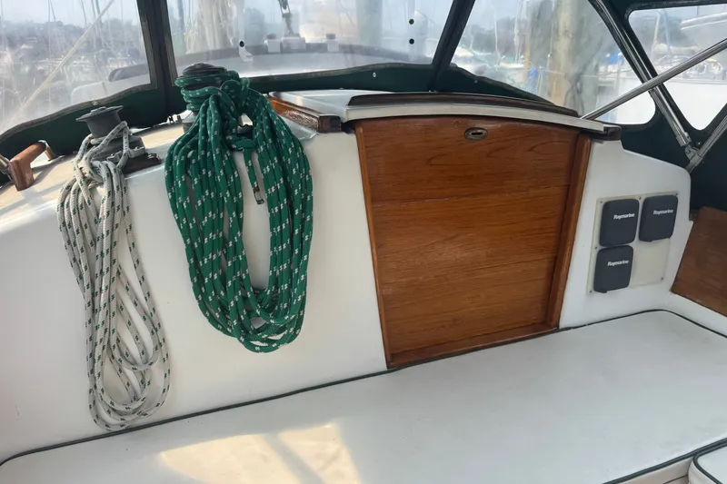 Slide: The Image of Cockpit of 1986 Cape Dory 36 sailboat with ropes and wooden hatch. - 15