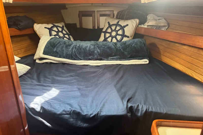 Slide: The Image of Cozy cabin interior of 1986 Cape Dory 36 sailboat with nautical-themed pillows. - 13