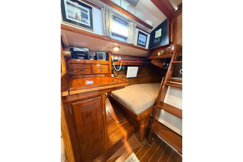 Slide: The Image of Cozy 1986 Cape Dory 36 yacht interior with wooden cabinetry and navigation station. - 7