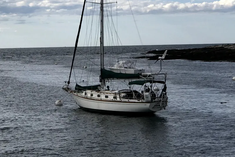 Slide: The Image of A 1986 Cape Dory 36 sailboat is anchored in calm waters. - 26