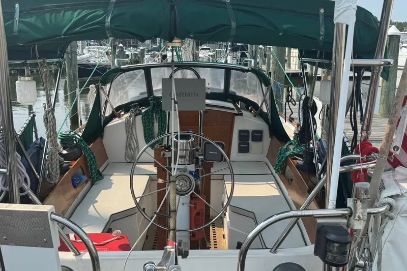 Slide: The Image of Cockpit of a 1986 Cape Dory 36 sailboat with green canopy and steering wheel. - 16