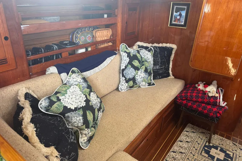 Slide: The Image of Interior of 1986 Cape Dory 36 sailboat with cozy seating and decorative pillows. - 11