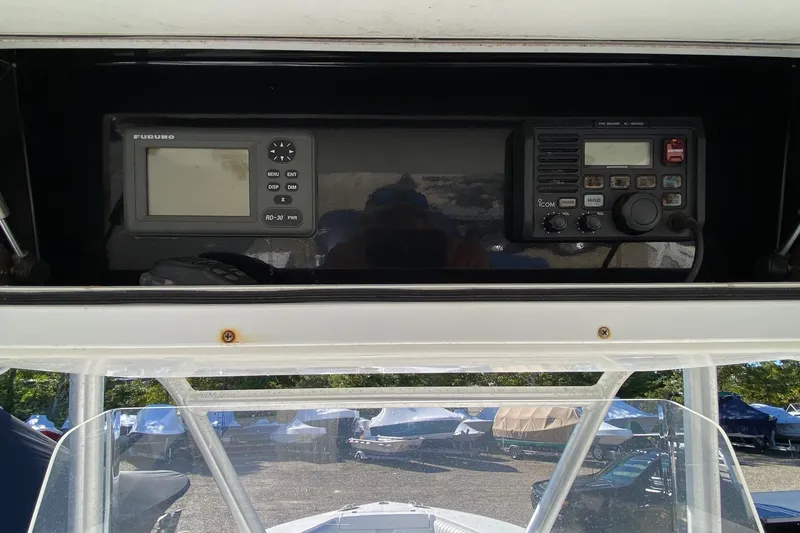 Slide: The Image of 2006 Regulator 23 Forward Seating boat dashboard with navigation and communication equipment. - 12