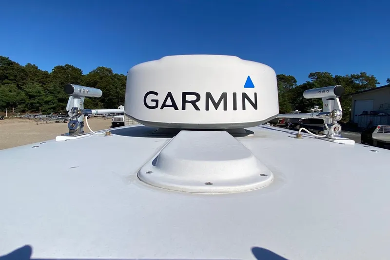 Slide: The Image of Garmin radar on 2006 Regulator 23 Forward Seating boat under clear blue sky. - 14