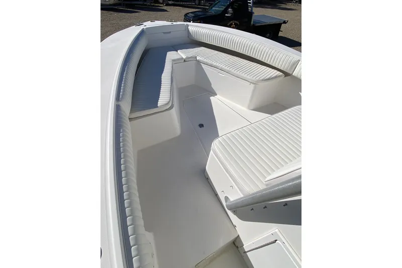 Slide: The Image of 2006 Regulator 23 Forward Seating boat interior with white cushioned seats. - 16