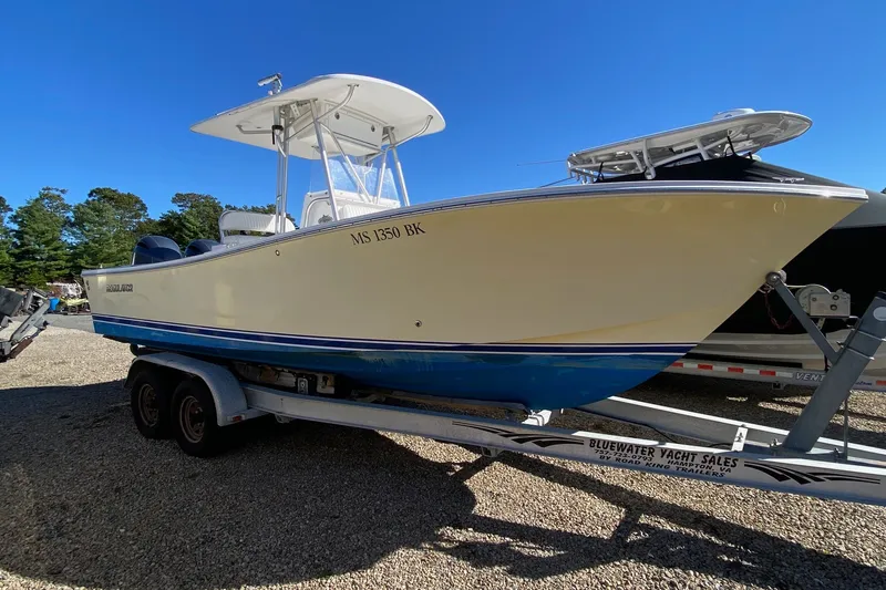 Slide: The Image of 2006 Regulator 23 Forward Seating boat on trailer under clear blue sky. - 1