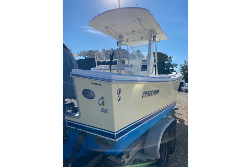 Slide: The Image of 2006 Regulator 23 Forward Seating boat on trailer under clear blue sky. - 4