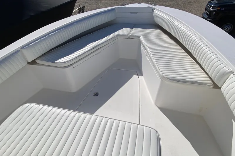 Slide: The Image of 2006 Regulator 23 Forward Seating boat with white cushioned seats and spacious layout. - 21