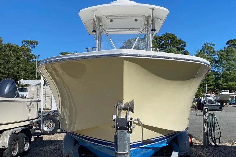Slide: The Image of 2006 Regulator 23 Forward Seating boat on trailer, parked outdoors. - 3