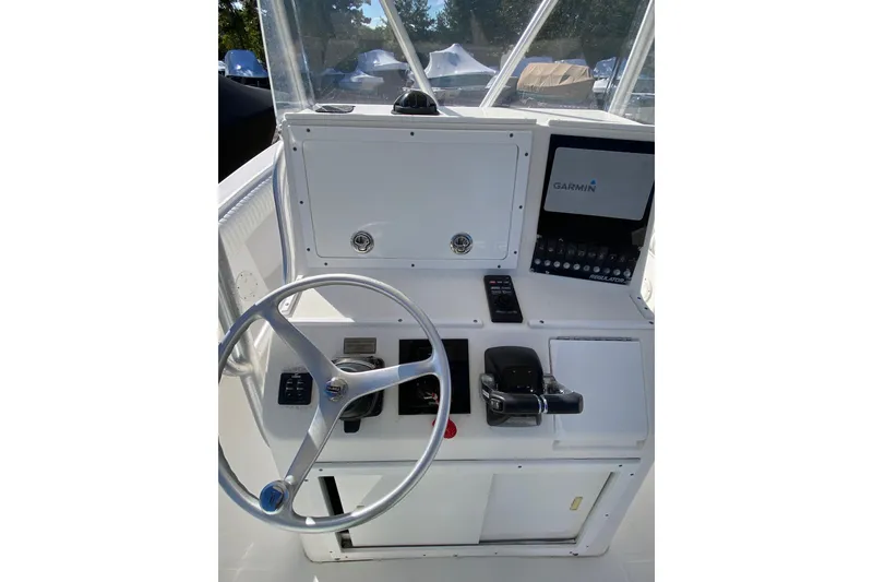 Slide: The Image of 2006 Regulator 23 Forward Seating boat dashboard with Garmin navigation system and steering wheel. - 15