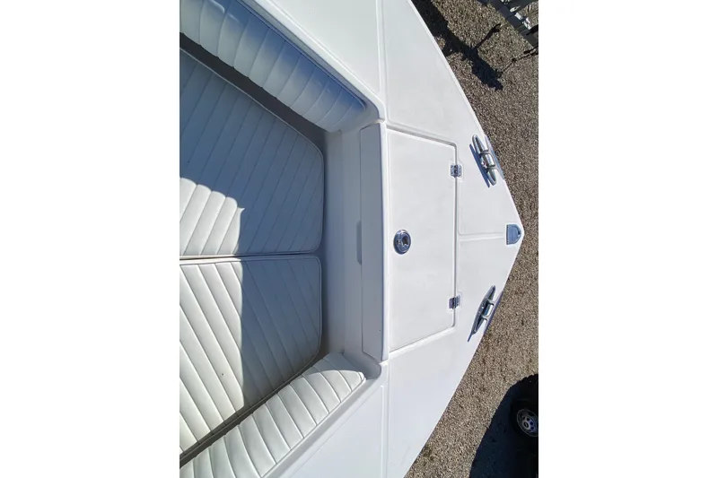 Slide: The Image of 2006 Regulator 23 Forward Seating boat with white cushioned seats and storage compartments. - 20