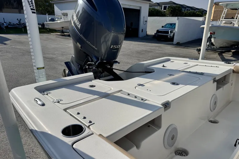Slide: The Image of 2020 Key West 210 Bay Reef boat with Yamaha 150 engine, docked outdoors. - 23