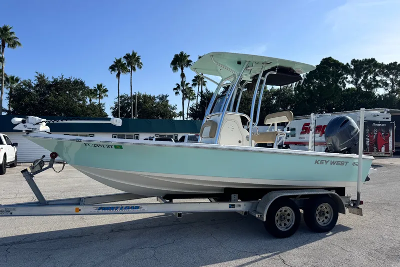 The Image of 2020 Key West 210 Bay Reef boat on trailer, parked outdoors under clear sky. - 13
