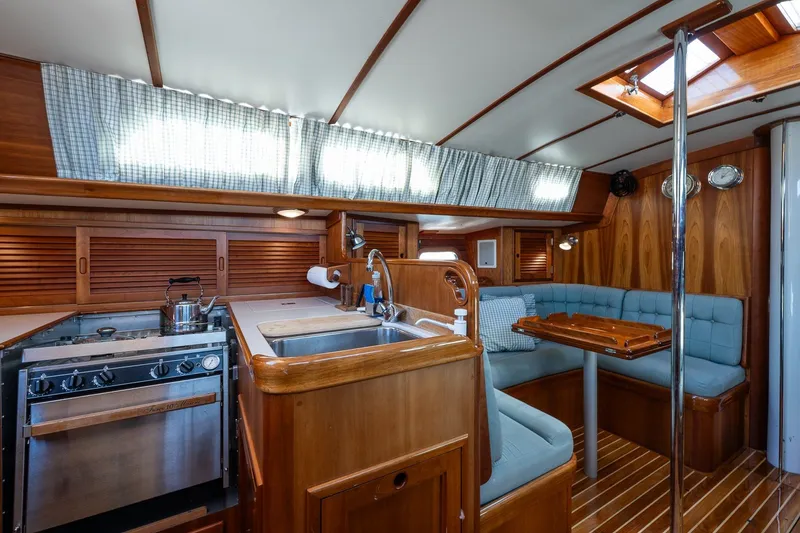 Slide: The Image of Interior of 1995 Hinckley Sou'wester 42 MKII yacht with wood finish and cozy seating area. - 14