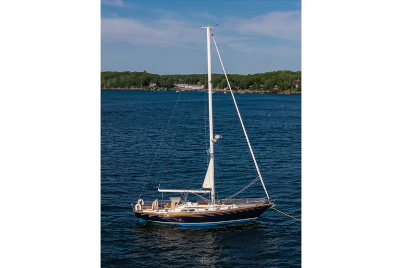 Slide: The Image of Sailboat Hinckley Sou'wester 42 MKII, 1995, anchored on a serene blue lake. - 6