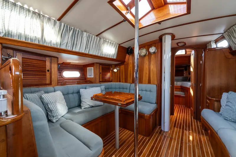 Slide: The Image of Interior of 1995 Hinckley Sou'wester 42 MKII yacht with wooden finishes and cozy seating. - 15